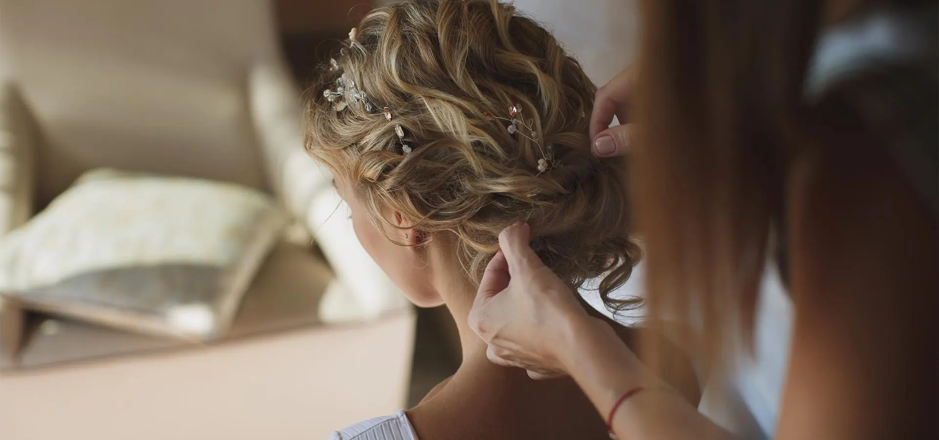 A person styling an intricate updo with hair accessories. A person styling an intricate updo with hair accessories.
