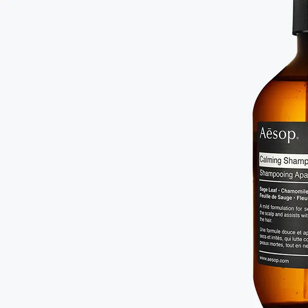 Close-up of an amber bottle with a black pump dispenser against a white background. Close-up of an amber bottle with a black pump dispenser against a white background.
