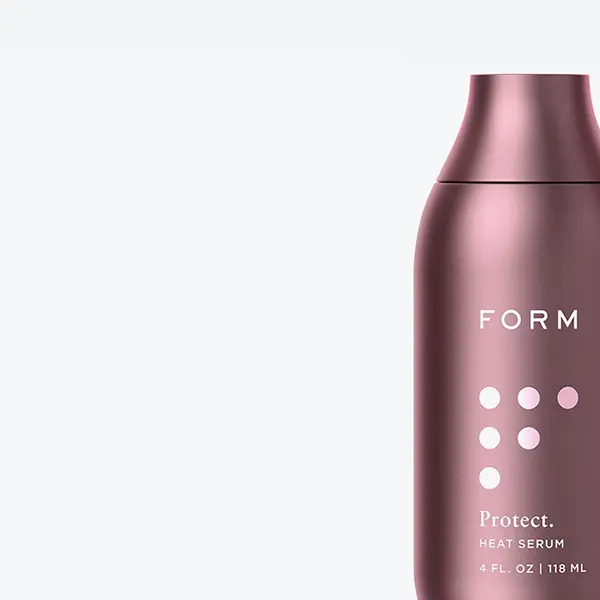 Sleek pink metallic bottle labeled ‘FORM’ with a minimalist design. Sleek pink metallic bottle labeled 'FORM' with a minimalist design.