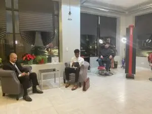 Men waiting in a barber shop lobby. Men waiting in a barber shop lobby.