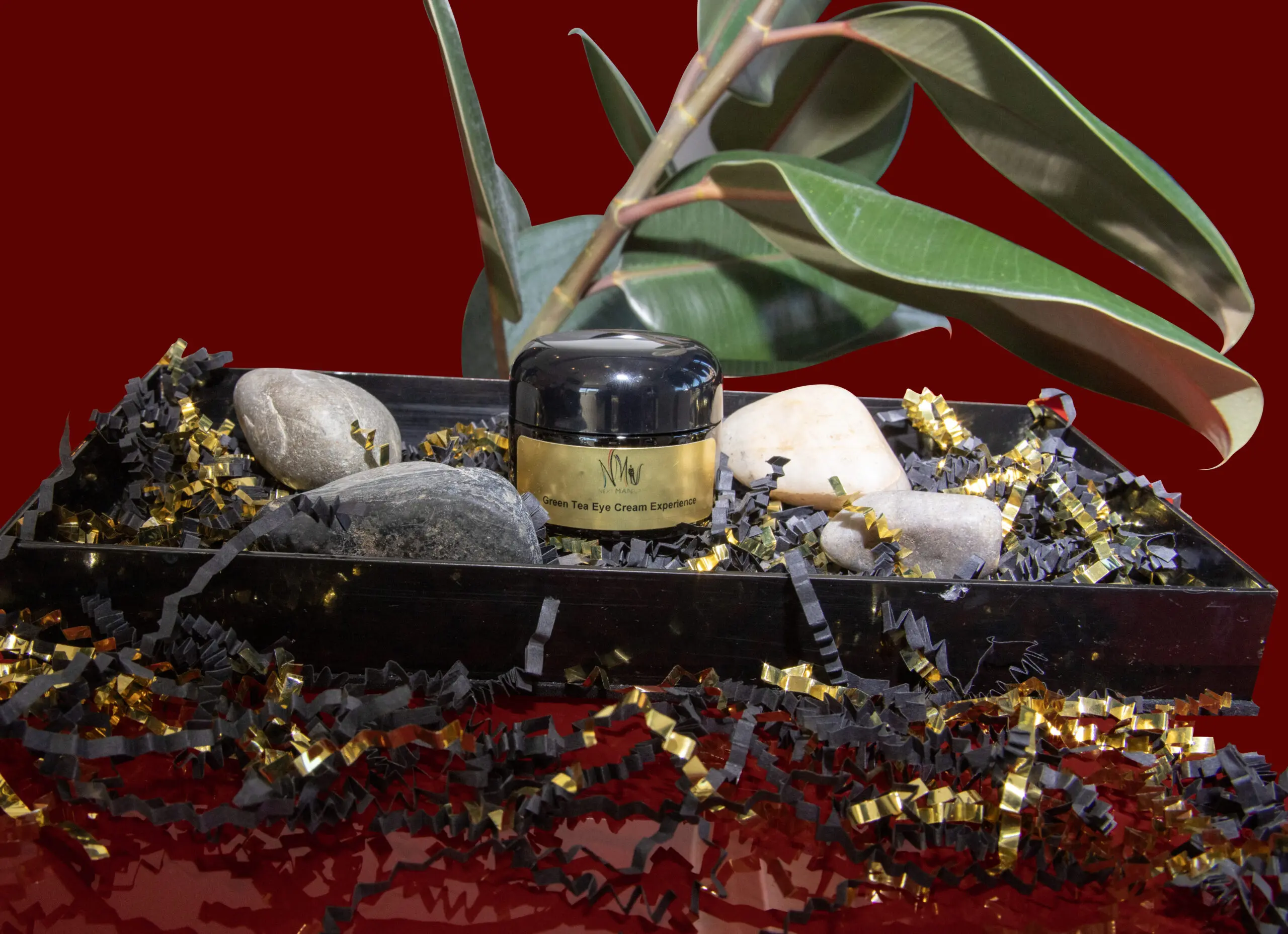 A jar of black cream on a decorative tray with stones and beads. A jar of black cream on a decorative tray with stones and beads.
