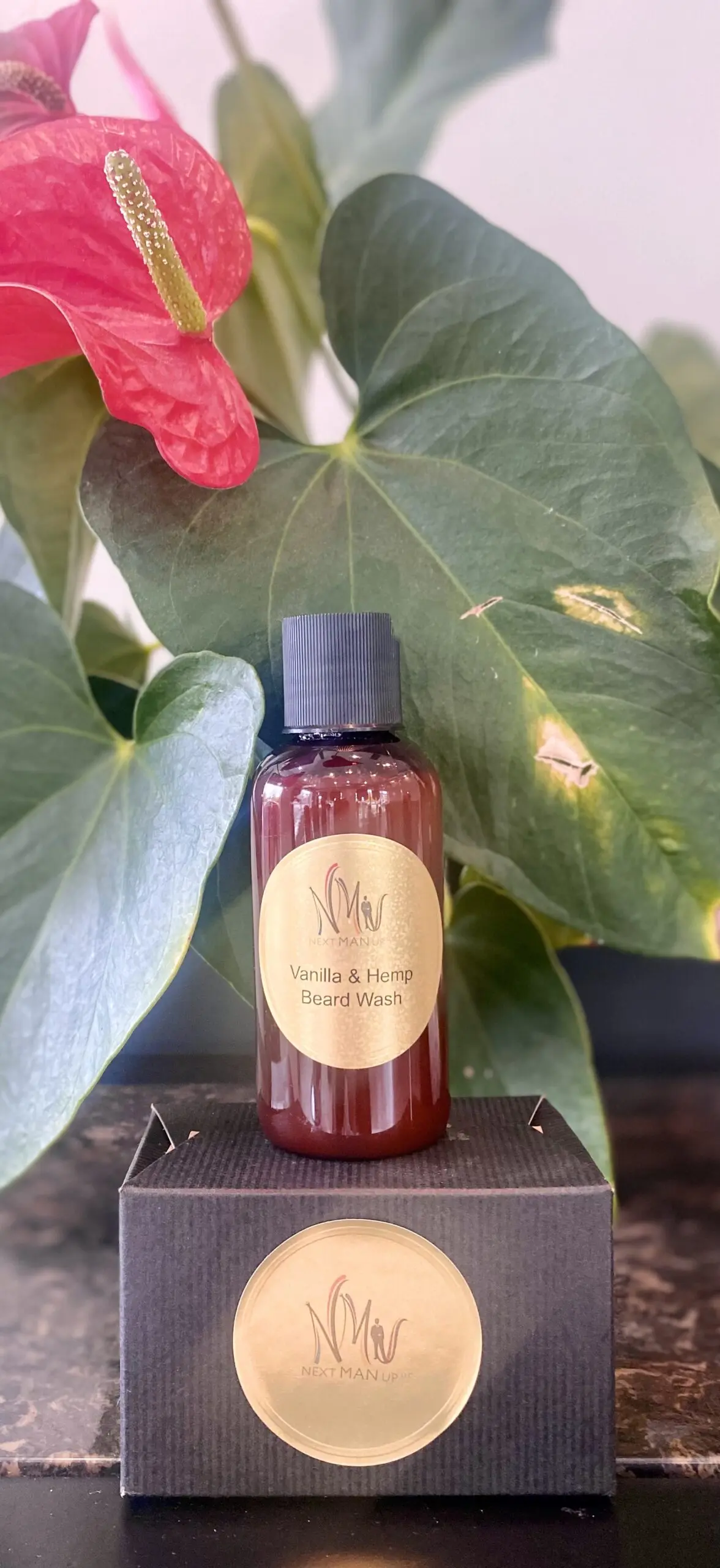 A bottle of rosehip seed oil with a leafy background.