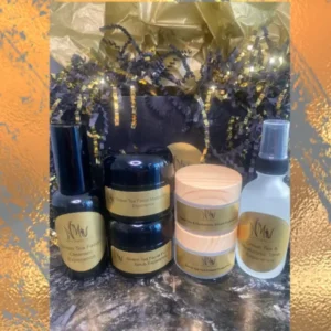 A collection of skincare products arranged on a marbled surface with warm lighting.