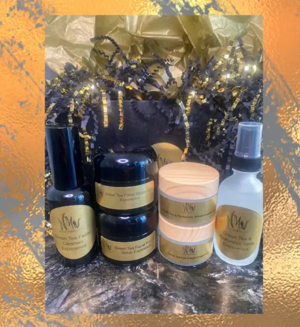 A collection of skincare products arranged on a marbled surface with warm lighting.