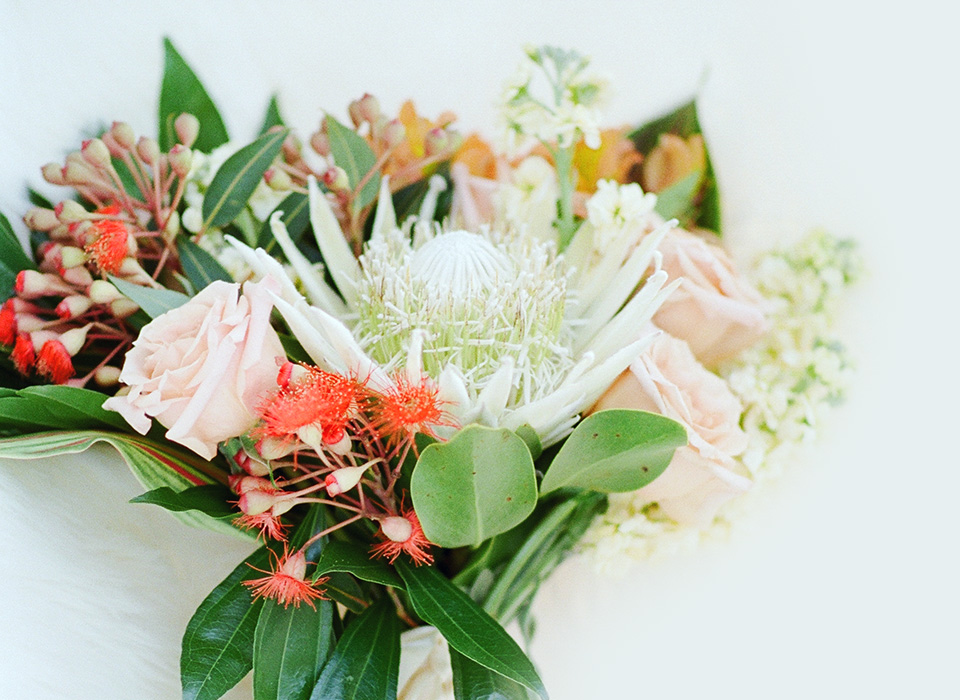 Elegant bouquet with pale pink roses and lush greenery.
