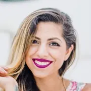 Smiling woman with vibrant pink lipstick and wavy hair. Smiling woman with vibrant pink lipstick and wavy hair.