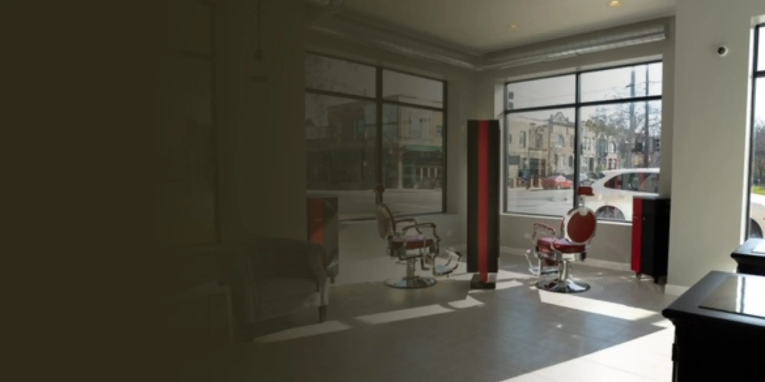 Modern, sunlit living room with large windows and city views. Modern, sunlit living room with large windows and city views.